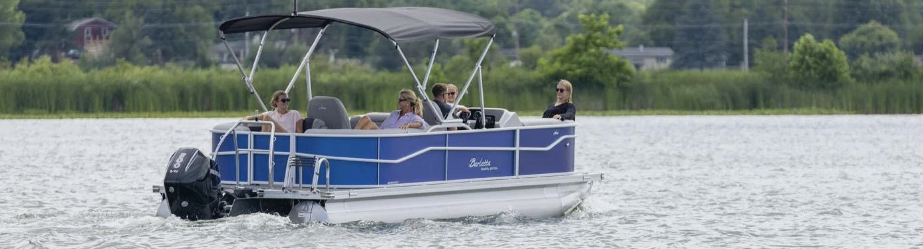 A 2020 Supra SA boat stationed on a lake.
