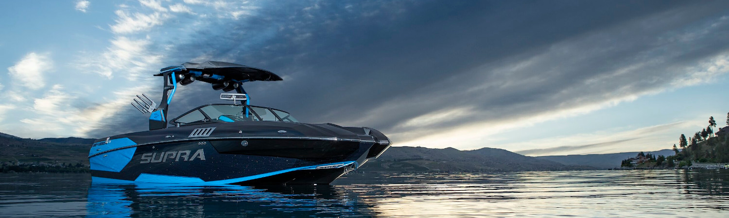 A 2020 Supra SA boat stationed on a lake.